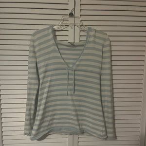 Long sleeve light blue and white striped hoodie. Features a low v cut neckline.